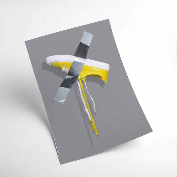 A4 print mockup - The image features a Yellow Cariuma OCA sneaker in collaboration with Pantone stuck to a wall with duck tape