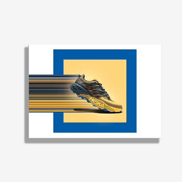 A4 print mockup - The image features a Hoka Speedgoat running shoe on a yellow background. There are colourful lines extending out of the back of it.