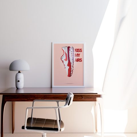 A3 print mockup in a frame on a desk - The image features a Nike Air Max sneaker in Red with the words 'Kiss my Airs' in bold type next to it.
