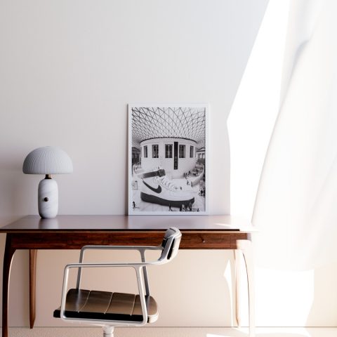 A3 print mockup in a frame on a desk - The image features a Nike Air Force 1 mid sneaker collaboration with Alyx as a giant shoe in the British Museum